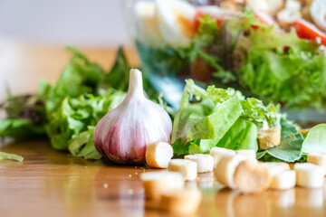 Close up view on Caesar salad in the plate. Preparation salad