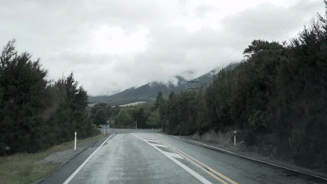 road in the middle of nelson lakes national park, with mountain views, new zealand