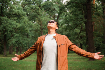 Happy young handsome man in a leather jacket