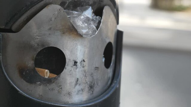 A close up view of a street ash tray.