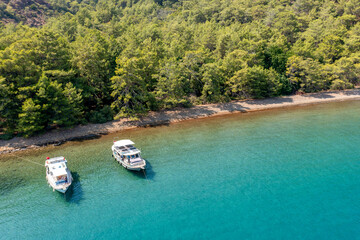 Fototapeta na wymiar Turquoise sea and aerial view of boats at Ekincik bay. 