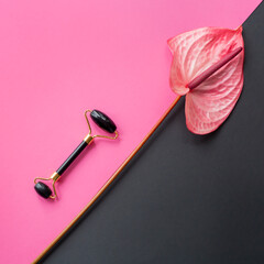 Black gua sha roller, Anthurium on pink and black square background
