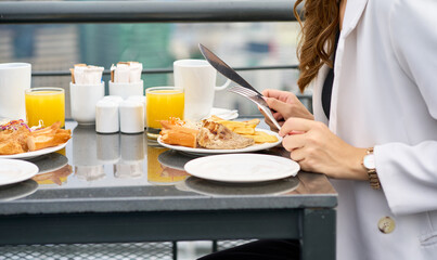 Lunch time with steak meal on rooftop restaurant with businesswoman