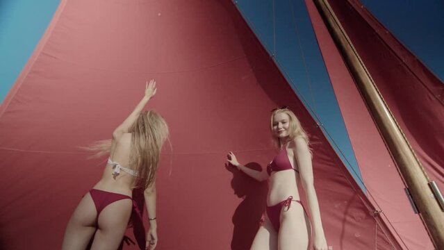 Pretty girls are dancing during a party on the sailboat