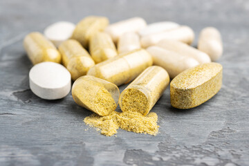 Mix of herbal supplement capsules and vitamin pills