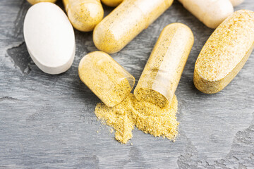 Mix of herbal supplement capsules and vitamin pills