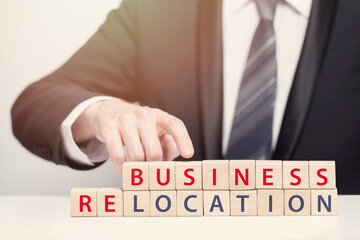 Businessman pointing at relocation inscription, relocation concept.