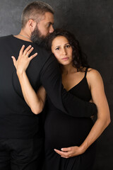 Fototapeta na wymiar A sad pregnant woman with a man