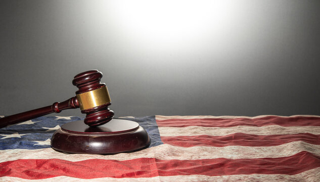 Judge gavel on United States flag with clear background - justice concept