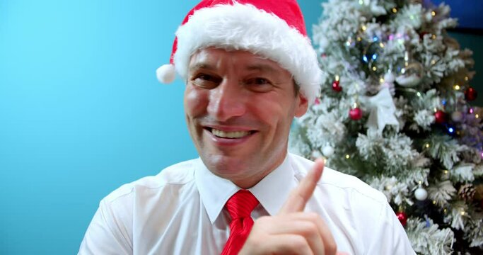 Portrait Smiling Serious dad Middle Aged in Christmas hat Santa Claus Man saying No by Finger Sign, looks in camera, disappointed man's face, bad surprise, man emotion something unpleasan.