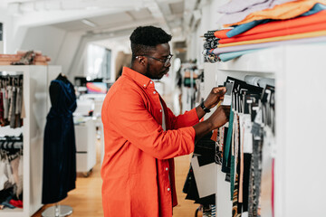Handsome black man working at his fashion designer studio. Small business concept.