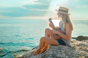 Smelling women relaxing and playing on ukulele on beach, so happy and luxury in holiday summer,...