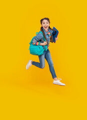 Energetic schoolgirl jumping, school. Excited teenage girl screaming in midair. School education