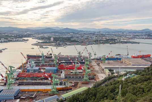 View of the colorful shipyard ocean port and harbor from the Ulsan bridge Observatory in Ulsan South Korea during a golden sunset