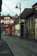 Medieval street and facade of historic buildings in city center of Sibiu Romania
