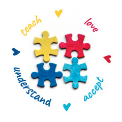 Autism World Awareness Day. Four puzzle pieces, different colors. Words love, teach, accept, understand around. Autism awareness symbol, mosaic on white background. Flat lay, top view, square