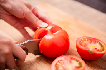 Preparing food, cutting tomatoes slices