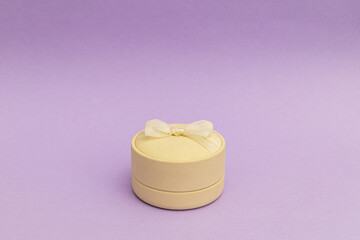 White ring box on a bright purple background