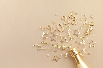 Christmas and New Year background with golden champagne bottle, party decorations, confetti stars...