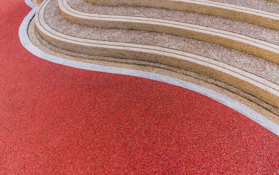 Red rubber floor and curve pebble stairs well space for text
