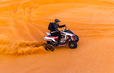 Offroad safari in sand desert, Empty Quarter Desert in United Arab Emirates. Quad bike on sand dune in Rub’ al Khali desert in sunset time.