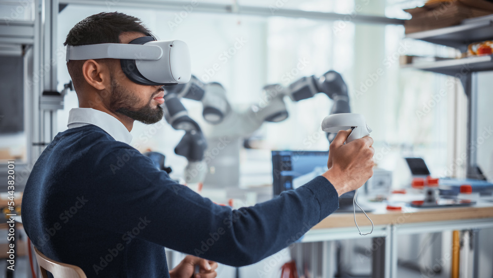 Poster Computer Science Worker in Virtual Reality Headset Holding Controllers and Moving Bionic Claw. Man Developing Program for Motion of Robotic Arm. Innovative Technologies for Automation Concept.