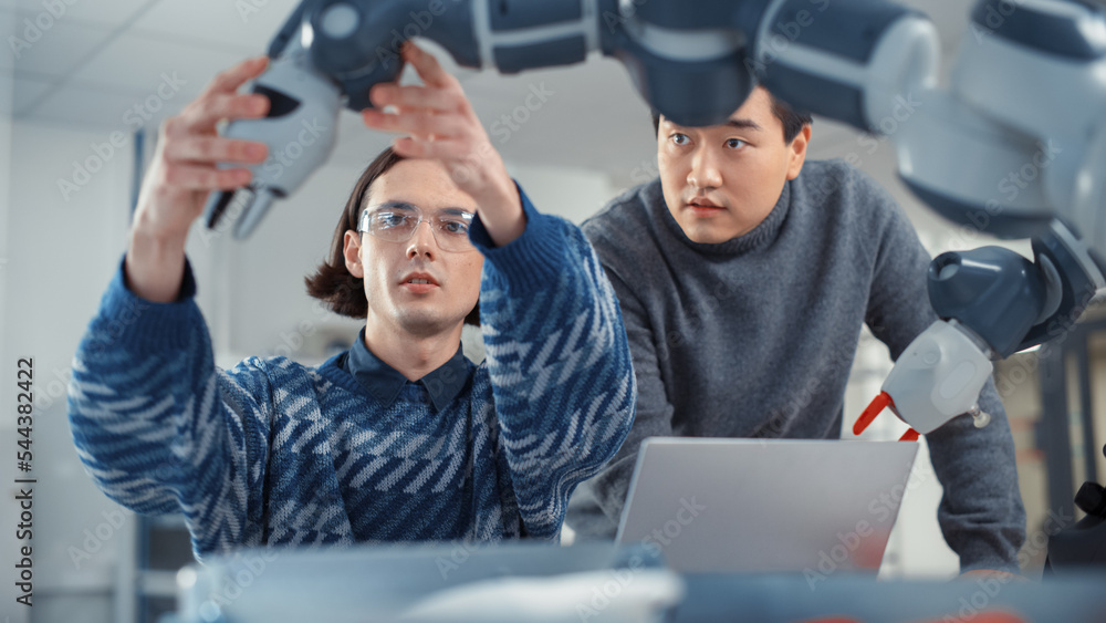 Poster young professional asian engineer looks at screen and tells his ideas to colleague that uses laptop 