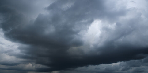 Storm clouds floating in a rainy day with natural light. Cloudscape scenery, overcast weather above blue sky. White and grey clouds scenic nature environment background
