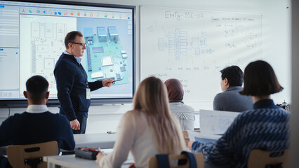 Confident Male Teacher Using Digital Interactive Screen, Talks to Group of Diverse Engineering...