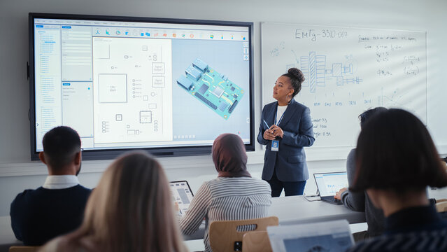Diverse Team of Computer Engineering Students Listening to Black Teacher on Seminar, Watching Interactive Whiteboard With 3D Model of Processor. Innovative Techniques in Technology Concept.