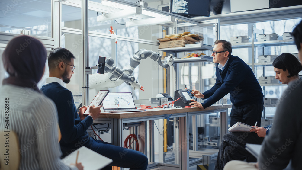 Aufkleber Diverse Computer Specialists Listen and Write While Senior Engineer Changing Position of Robotic Arm with Controller. Intellectual Youth in Modern Educational Environment Concept.