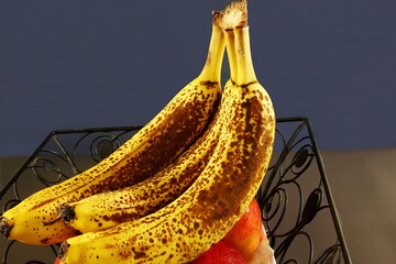 isolated fresh organic over ripe dark brown spots yellow banana fruit on dark background