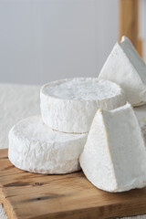 Different geometric forms of camamber cheese. Multiform cheese camamber brie composition. Selective focus