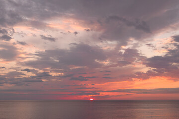 Calm sea with sunset sky with cloud.