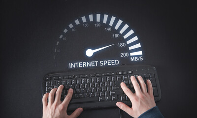 Male hands typing in keyboard. Speedometer. Internet speed