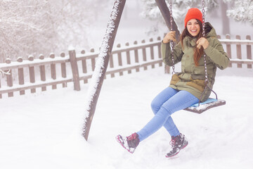 Woman playing on the swing while on winter vacation