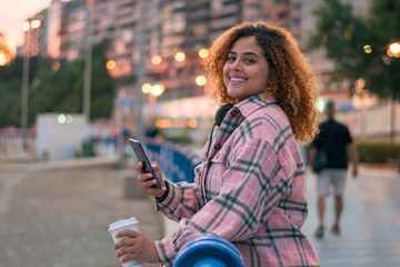 Curvy woman with curly hair looking the camera smiling