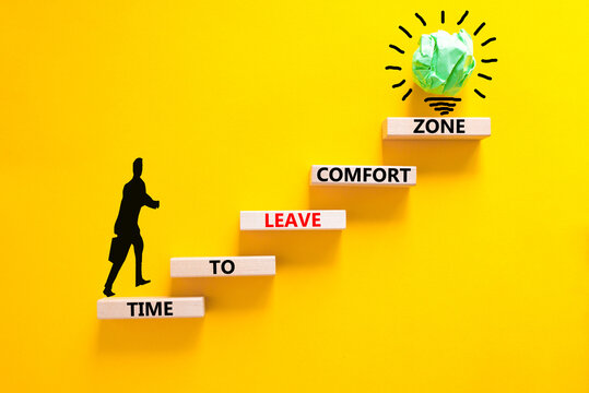 Leave comfort zone symbol. Concept words Time to leave comfort zone on wooden blocks. Businessman icon. Beautiful yellow background. Business time to leave comfort zone concept. Copy space.