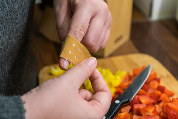 A woman cuts her finger and puts a plaster on it