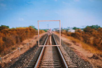 Picture framed artwork with hands popping up.