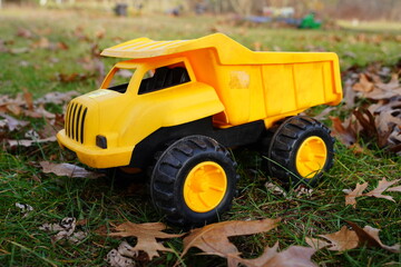Yellow toy dump truck sits outside