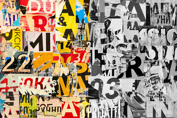 Collage of many numbers and letters ripped torn advertisement street posters grunge creased...