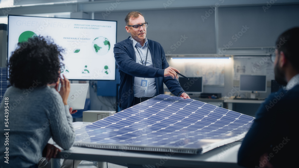 Poster chief engineer points at projection screen and talks about green energy and solar panels future poss