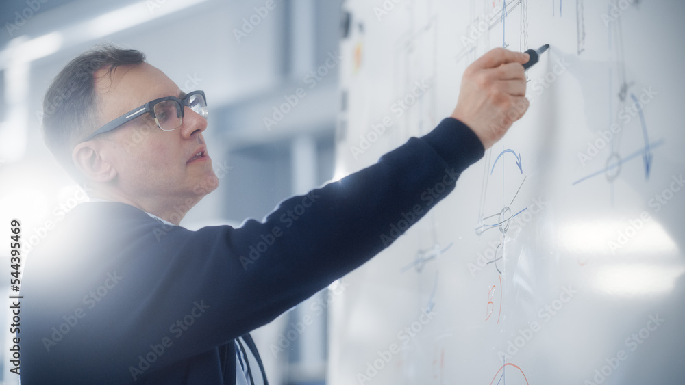 Poster male teacher writes and draws car engine prototypes on the whiteboard while giving lecture or leadin