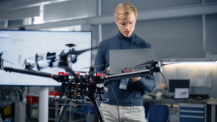 Young Male Developer Programming on Laptop Computer. Working on a New Drone Design in the Research...