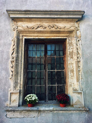 Old window with flowers on sill