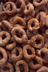 freshly finished handmade spanish christmas donuts with icing sugar - top view - portrait orientation