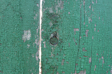 old wooden background of painted boards with cracked and peeling paint