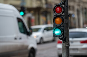 traffic light on the street junction with beautiful bokeh, city with cars in the background