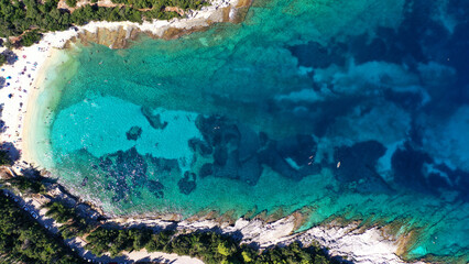 Aerial drone top down photo of tropical exotic paradise secluded rocky bay with deep turquoise sea forming a blue lagoon